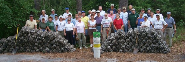 Photo of SCORE volunteers posing with their filled shell bags.
