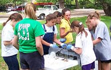 Photo of students sorting benthic organisms collected from a restored SCORE reef site.